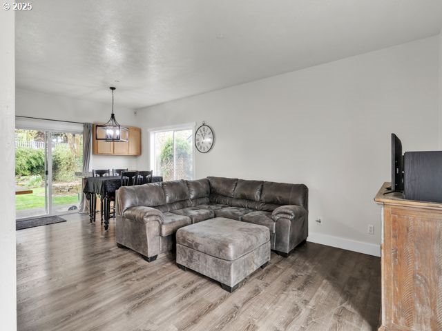 724 Kayla Way, Monmouth, OR 97361 - living room featuring baseboards and wood finished floors