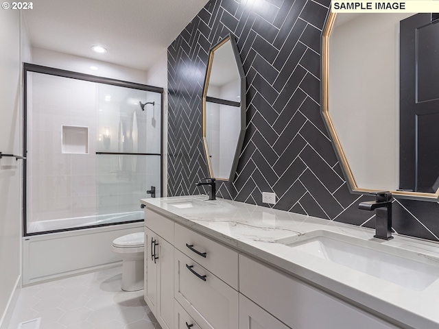 full bathroom with shower / bath combination with glass door, toilet, tile patterned floors, tile walls, and vanity