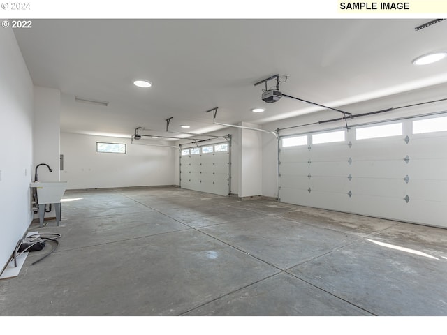 garage featuring a garage door opener and sink