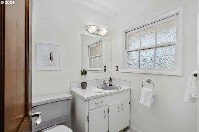 half bathroom with toilet and vanity