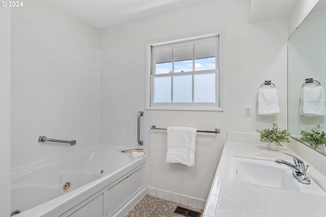 bathroom with baseboards, visible vents, a whirlpool tub, tile patterned flooring, and vanity