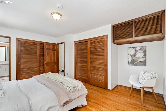 bedroom with light wood-style floors and baseboards