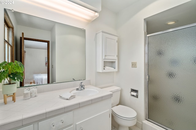 ensuite bathroom with vanity, a stall shower, connected bathroom, and toilet