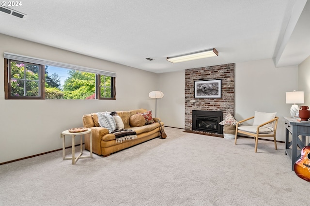 living room featuring a brick fireplace, carpet, visible vents, and a textured ceiling