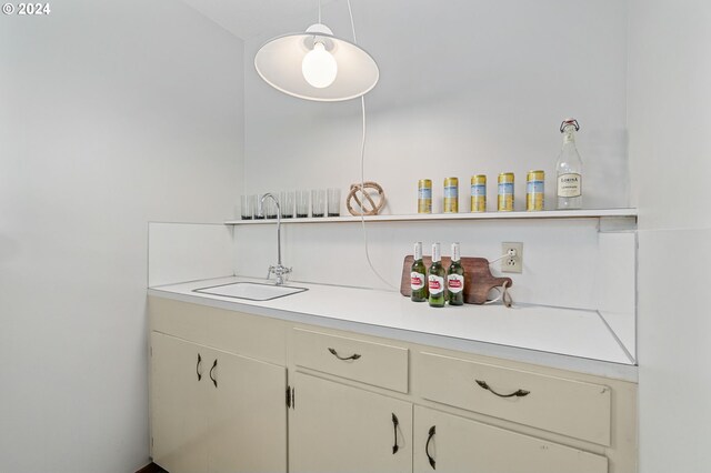 bar with white cabinets and pendant lighting