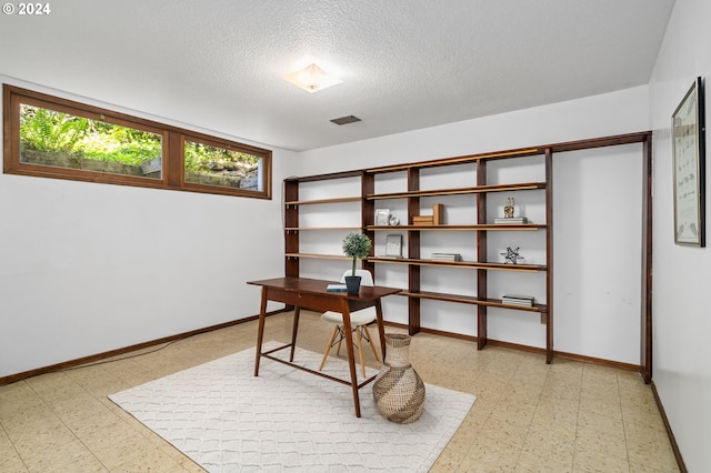 home office featuring baseboards, a textured ceiling, visible vents, and tile patterned floors