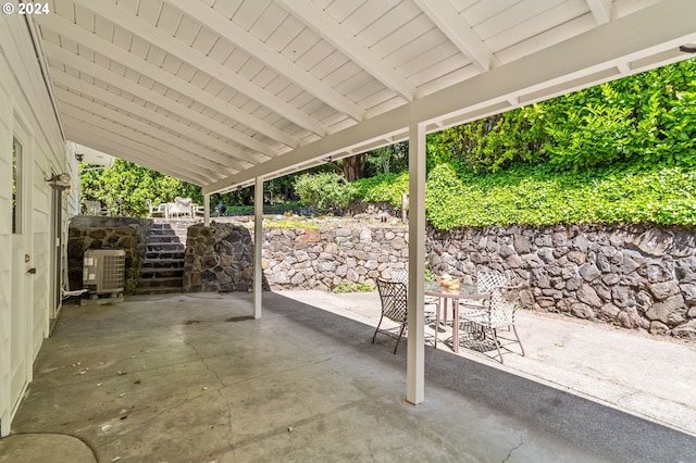 view of patio with outdoor dining area and central AC