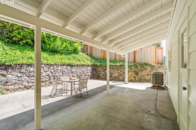 view of patio / terrace featuring outdoor dining area, fence, and central AC unit