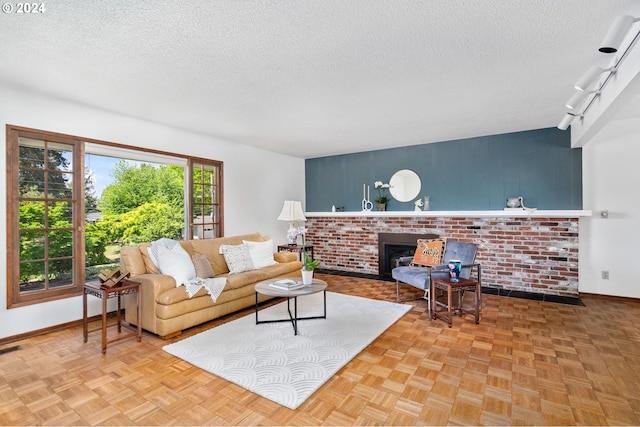 living room with a textured ceiling, a fireplace, and baseboards