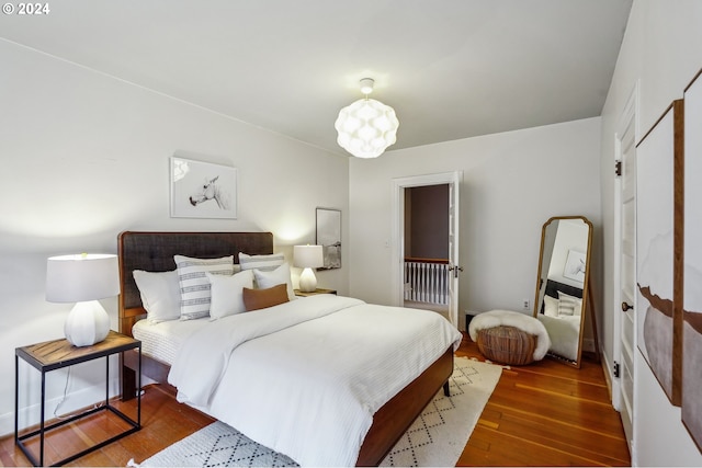 bedroom with dark wood-type flooring