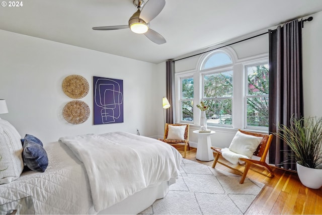 bedroom with ceiling fan and light hardwood / wood-style floors