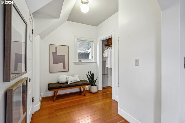 hall with hardwood / wood-style flooring