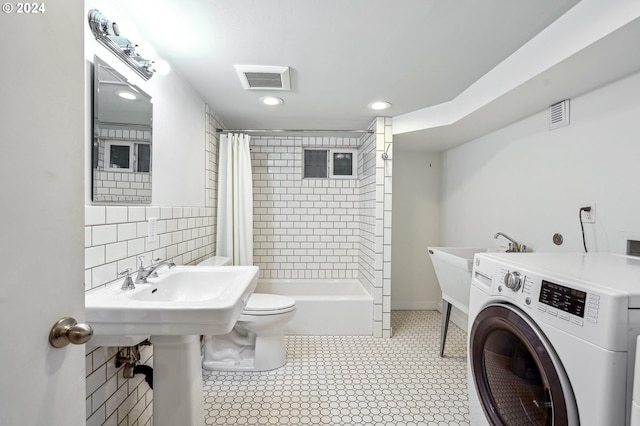 full bathroom featuring shower / tub combo, washer / clothes dryer, toilet, and sink