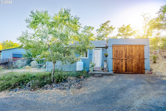 view of front of house featuring an outbuilding