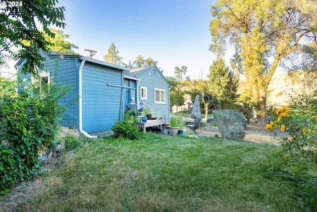 rear view of house with a lawn