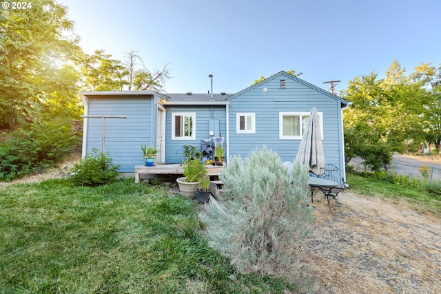 rear view of property with a lawn