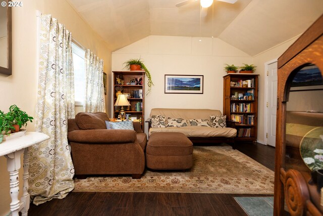 living room featuring ceiling fan, vaulted ceiling, and wood-type flooring