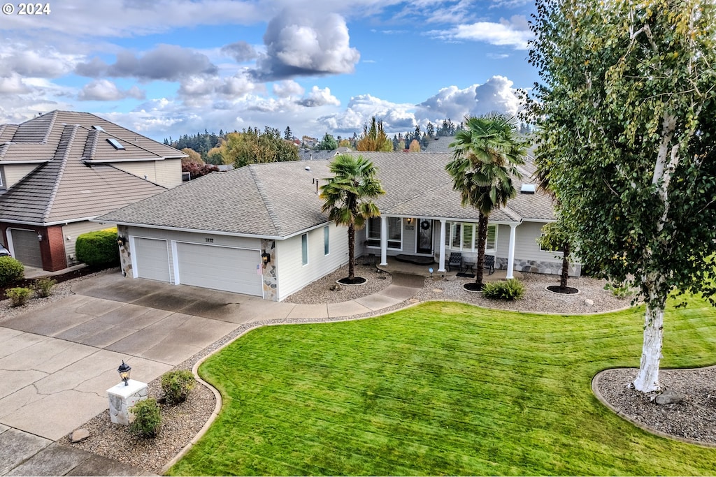 view of front of property with a garage and a front lawn