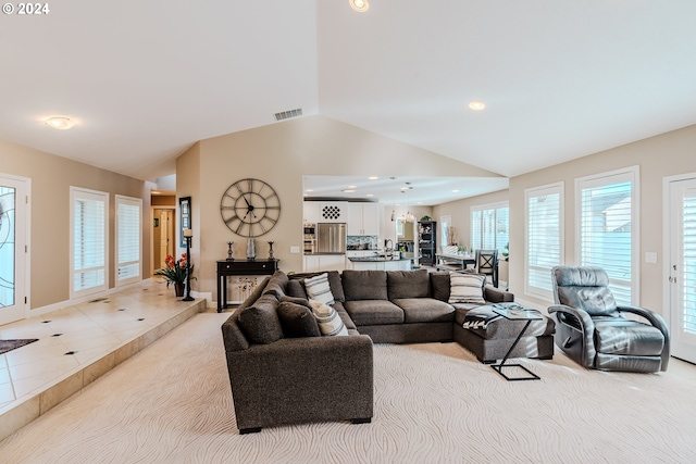 tiled living room with high vaulted ceiling