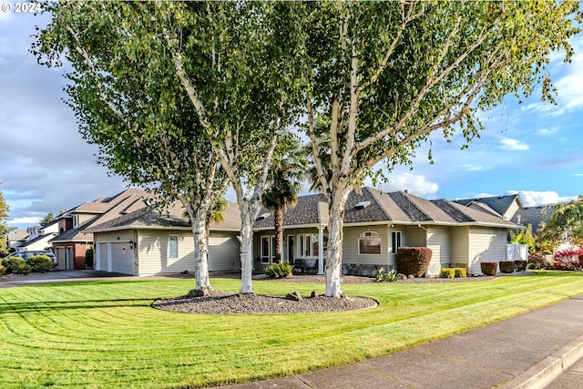 single story home featuring a garage and a front lawn