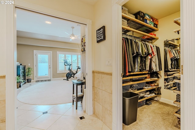 spacious closet featuring ceiling fan and carpet