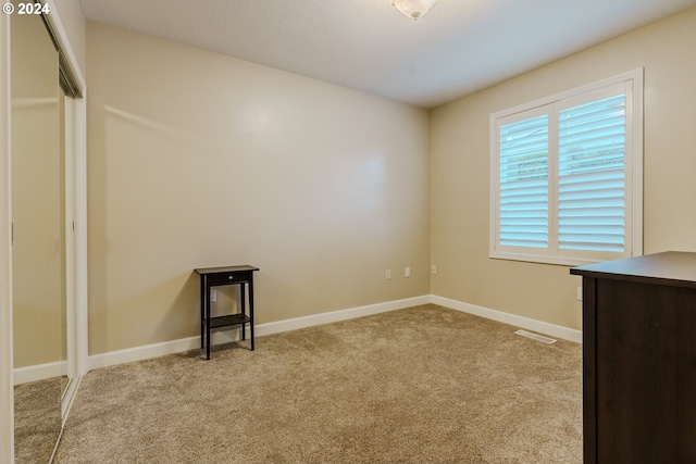 empty room featuring light carpet