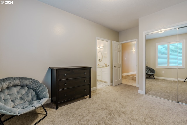 sitting room featuring light colored carpet