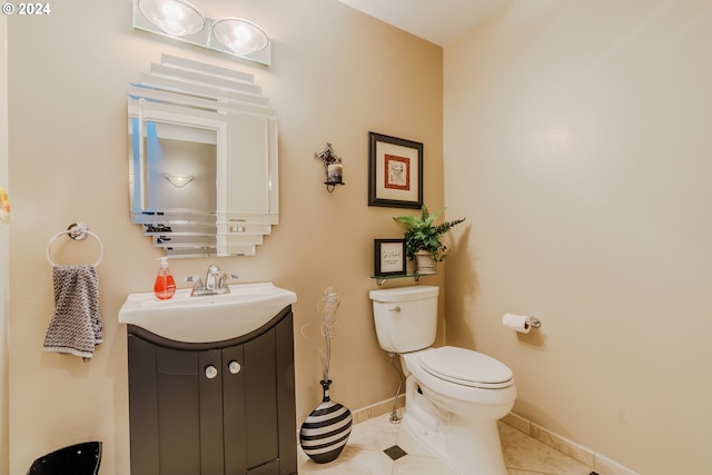 bathroom featuring vanity, tile patterned floors, and toilet