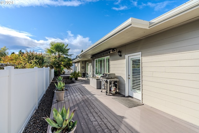 wooden terrace featuring grilling area