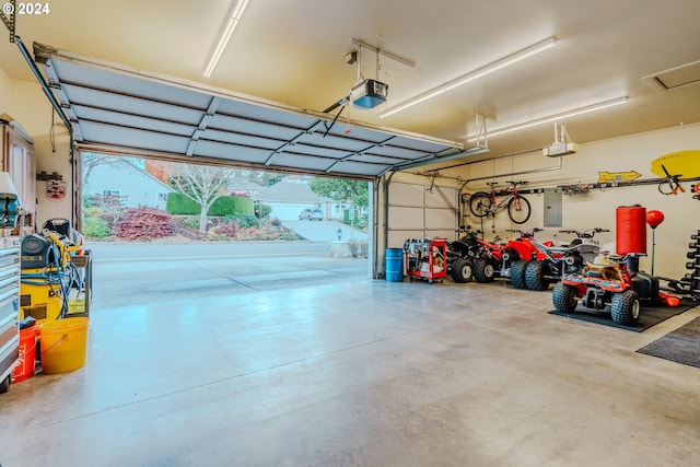 garage featuring a garage door opener and electric panel