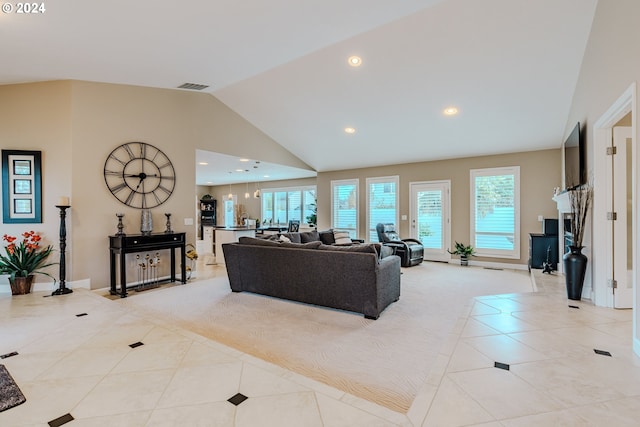 tiled living room featuring high vaulted ceiling