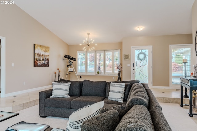 tiled living room with a notable chandelier, lofted ceiling, and a wealth of natural light