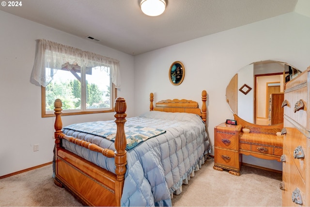 carpeted bedroom with lofted ceiling