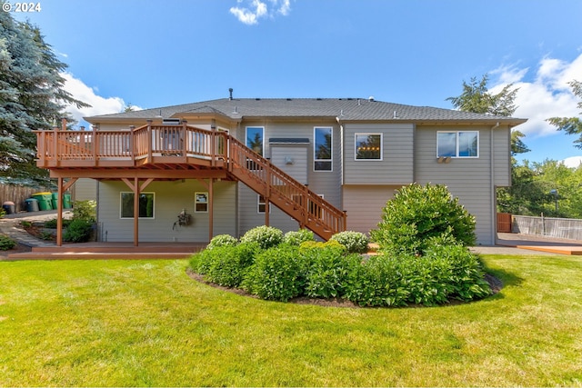 rear view of house with a patio, a yard, and a wooden deck