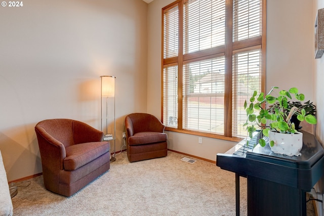 living area featuring light carpet