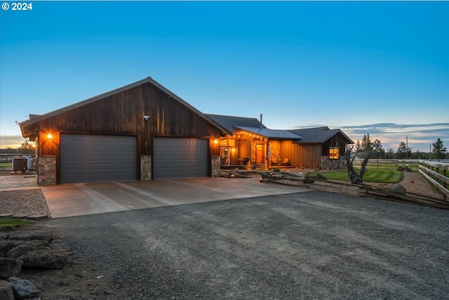 view of front of home featuring a garage and central AC unit