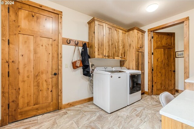 6150 NW Kingwood Ave, Redmond, OR 97756 - washroom with cabinet space, washing machine and clothes dryer, and baseboards