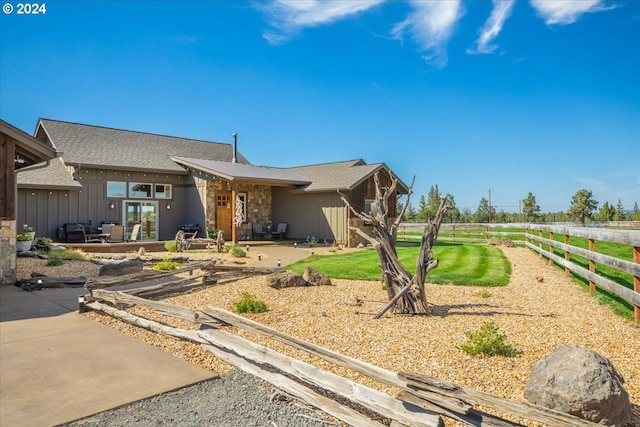 6150 NW Kingwood Ave, Redmond, OR 97756 - view of front of home featuring fence, a patio area, board and batten siding, and a shingled roof