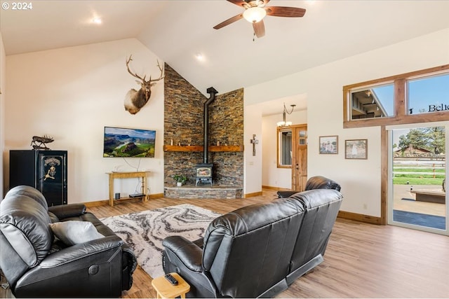 6150 NW Kingwood Ave, Redmond, OR 97756 - living area featuring high vaulted ceiling, ceiling fan, light wood-style floors, a wood stove, and baseboards