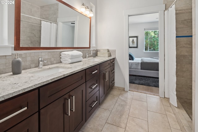 bathroom with decorative backsplash, tile patterned floors, and vanity