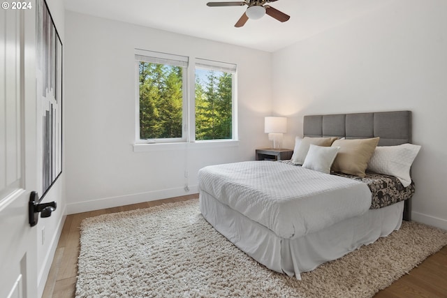 bedroom with hardwood / wood-style floors and ceiling fan