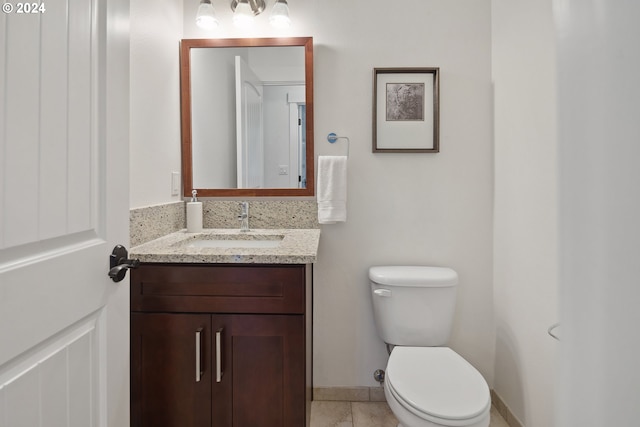 bathroom with tile patterned floors, toilet, and vanity