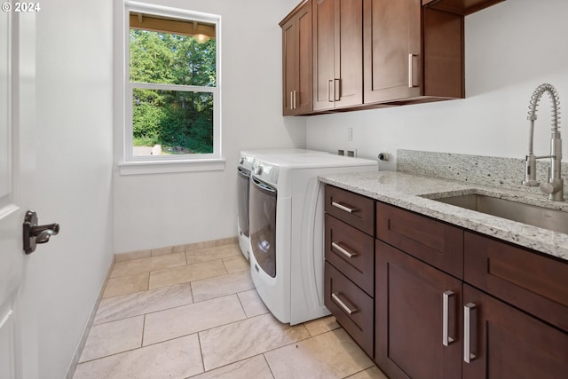 washroom featuring cabinets, light tile patterned floors, separate washer and dryer, and sink