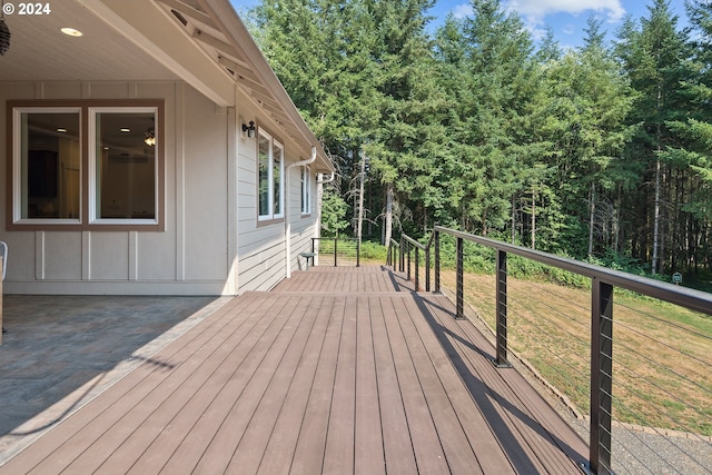 wooden terrace featuring a lawn