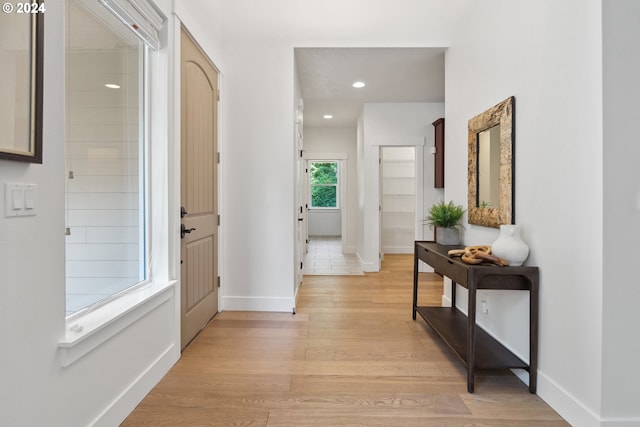 corridor with light hardwood / wood-style flooring