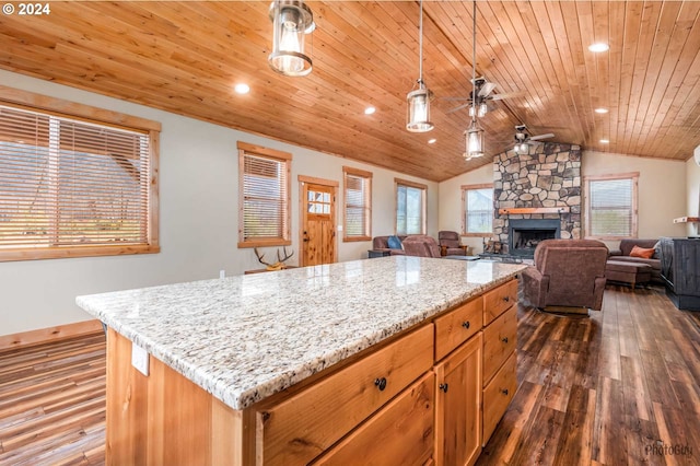 kitchen with pendant lighting, a fireplace, dark hardwood / wood-style flooring, wood ceiling, and ceiling fan