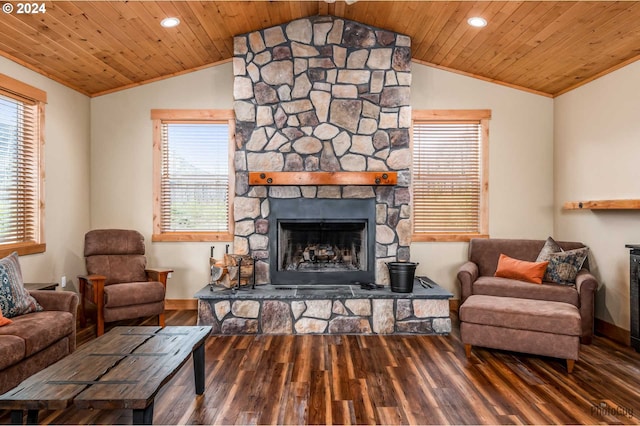 living room with dark hardwood / wood-style floors, vaulted ceiling, and a stone fireplace