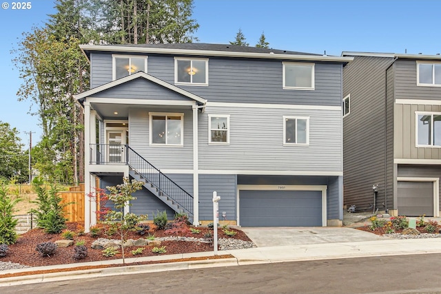 view of front of house featuring driveway, an attached garage, stairs, and fence