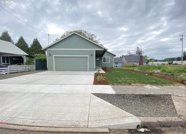 view of front of house featuring a garage and a front lawn