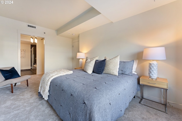 carpeted bedroom featuring ensuite bathroom